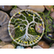 view from above small wire wrap tree of life in bed of river rock and moss